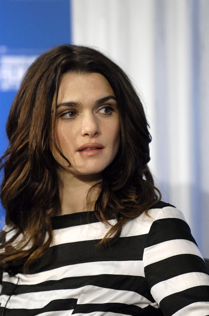 a woman in black and white striped shirt sitting down