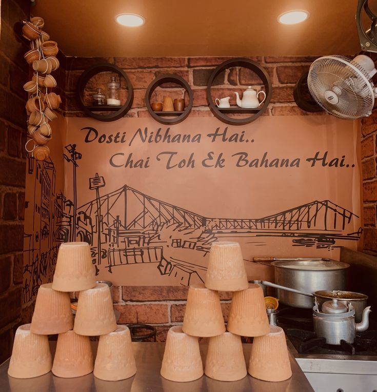 there are many lamps on the counter in this kitchen with a sign above it that says dosti nihanna hai chat toh ete & bahand hai