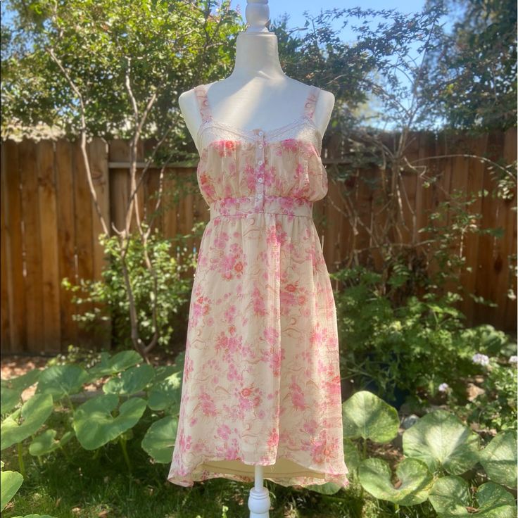 Kimchi Blue Carried At Anthropologie. A Sweet Garden Party Of A Dress! Lacey Straps And Trimming Along The Bodice, Button Front, Empire Waist, Side Zipper Closure, Fully Lined, High Low Hemline. Approx Measurements Laying Flat: Bust 18” Waist 14.5” Length Front 31” Back 38” Pink Knee-length Cute Midi Dress, Cute Pink Knee-length Midi Dress, Pink Knee-length Sundress For Brunch, Pink Floral Print Mini Dress For Daytime, Pink Knee-length Summer Sundress, Pink Knee-length Sundress For Spring, Daytime Pink Floral Print Mini Dress, Pink Feminine Sundress For Daywear, Pink Sundress Midi Dress For Daytime