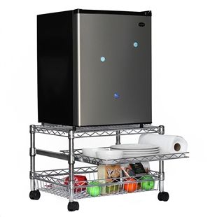 a silver refrigerator sitting on top of a metal shelf next to a roll of toilet paper