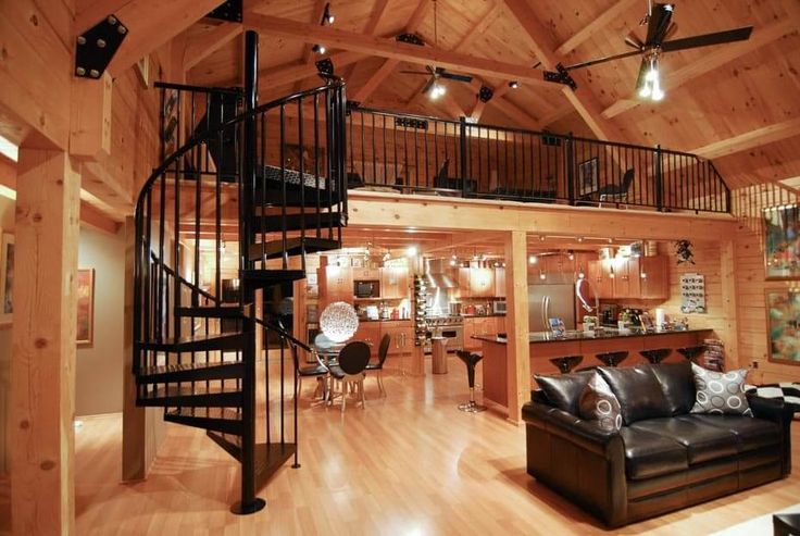 a living room filled with furniture and a spiral staircase