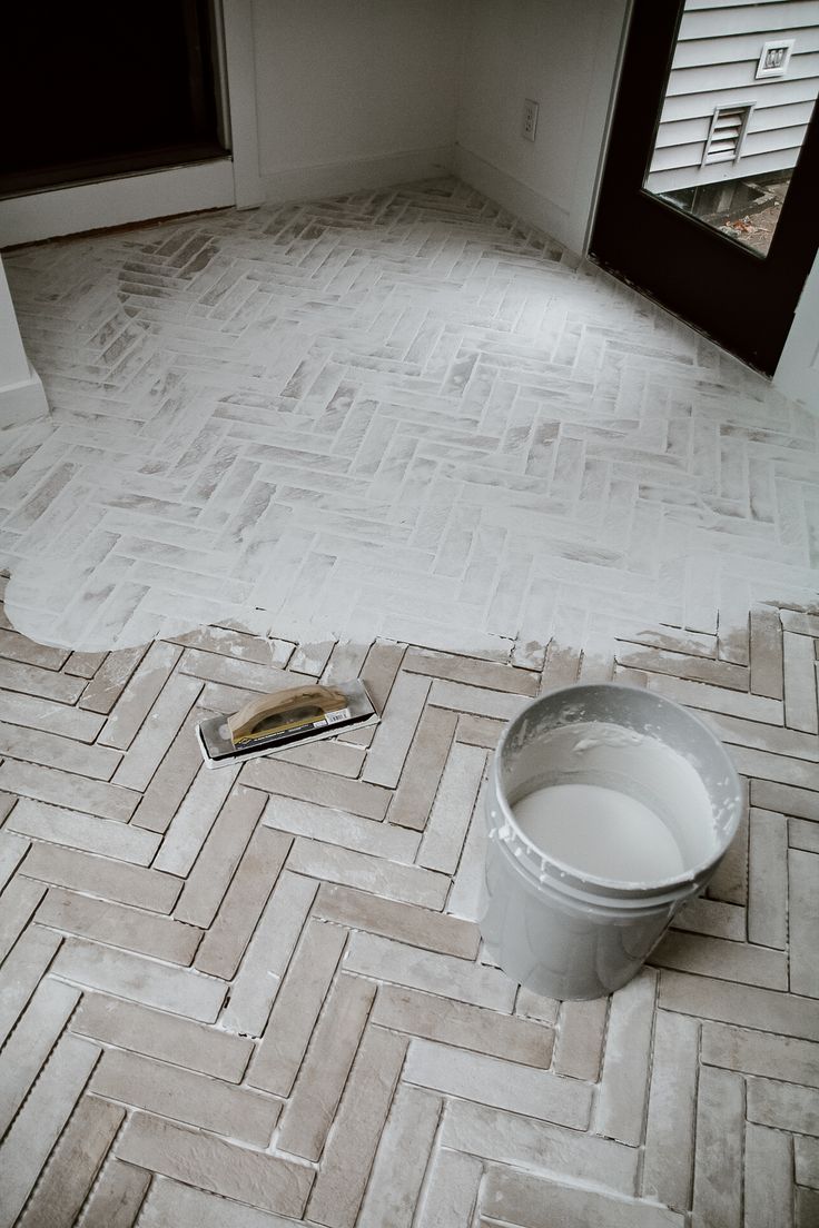 a bucket and brush sitting on the floor