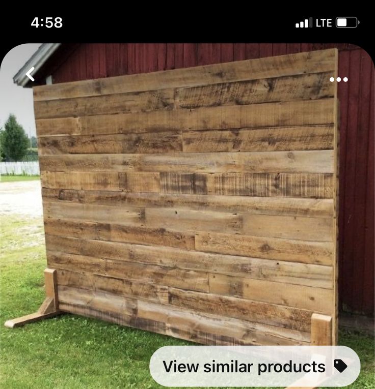 a wooden fence sitting next to a red barn