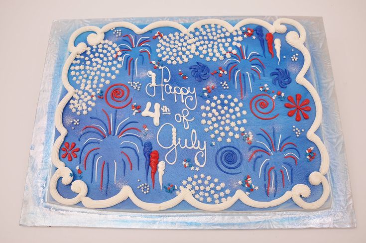 a blue cake with white frosting and fireworks on it that says happy fourth of july