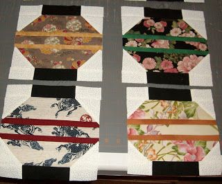 four different pieces of fabric are laid out on a piece of cloth with flowers and ribbons