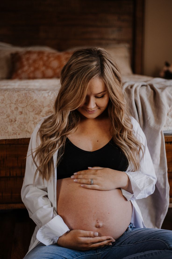 a pregnant woman sitting on her stomach