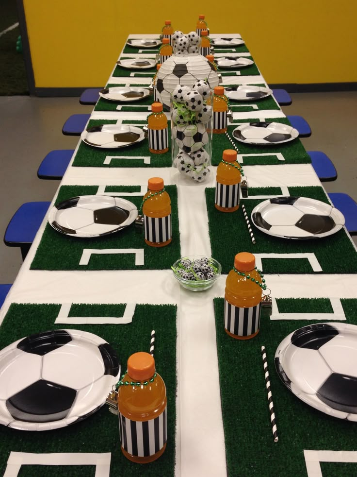 a table set up with soccer themed decorations