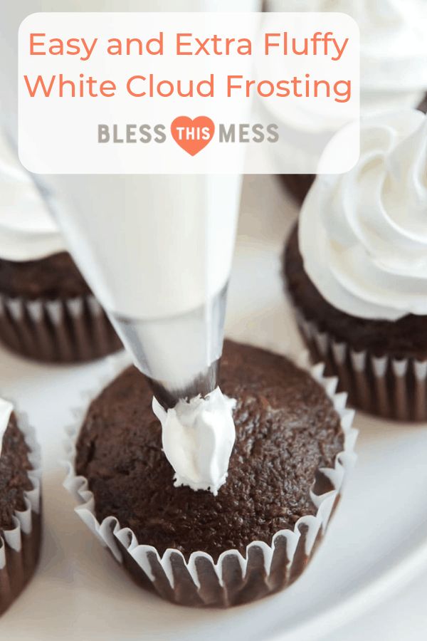 cupcakes being frosted with icing on a white plate and the words easy and extra fluffy white cloud frosting