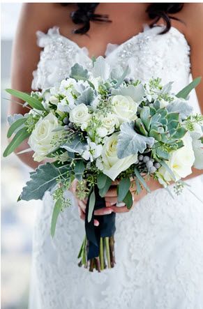 the bride is holding her wedding bouquet