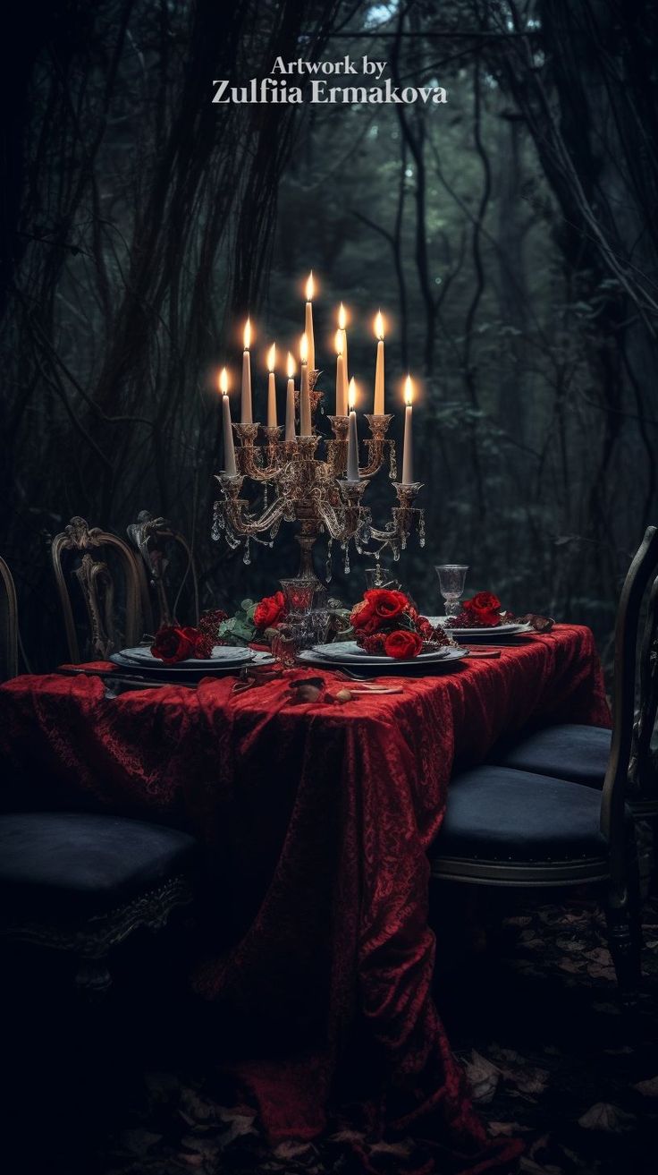 an image of a table with candles in the middle and red cloth on it, surrounded by trees