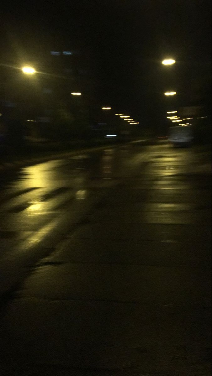 an empty street at night with the lights on