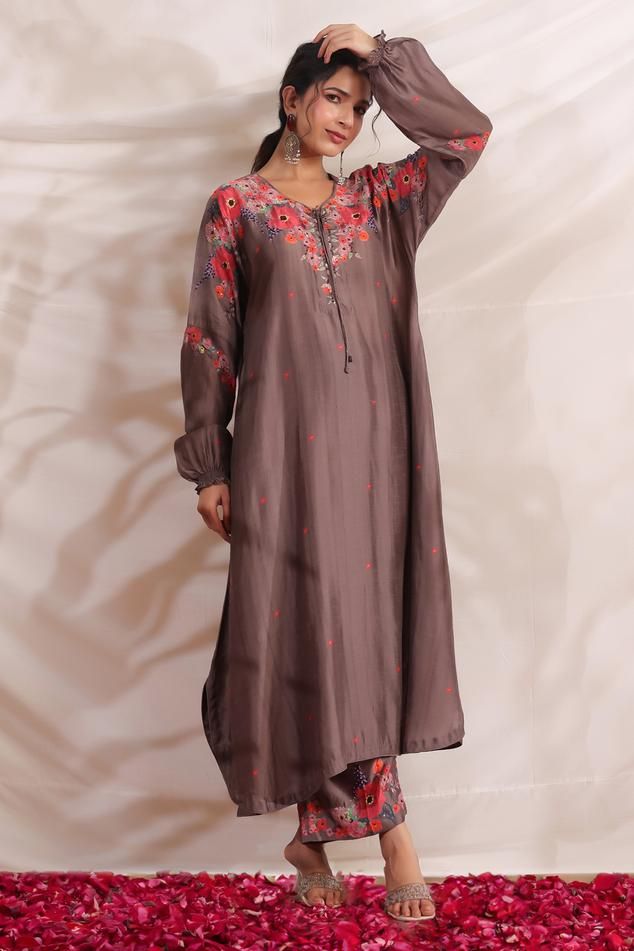 Brown silk asymmetric kurta with side pockets, multi color placement floral print, sequin, bead and French knot thread embroidered highlights. Paired with palazzo with printed border.
Components: 2
Pattern: Printed and Hand Embroidered
Type Of Work: Bloom Print, Bead, Sequin and French Knot Thread Work
Neckline: V Neck
Sleeve Type: Puff Sleeves
Fabric: Silk
Color: Brown
Other Details: 
Embroidered yoke
Curved hem
Side slits
Embroidered highlights
Model height: 5ft inches, wearing size S
Kurta Cl Festive Tissue Silk Sets With Printed Motifs, Semi-stitched Raw Silk Sets With Printed Motifs, Silk Salwar Kameez With Printed Motifs For Wedding, Wedding Kurta In Raw Silk With Printed Motifs, Wedding Kurta With Printed Motifs In Raw Silk, Wedding Silk Salwar Kameez With Printed Motifs, Elegant Multicolor Cotton Silk Sets, Silk Sharara With Printed Motifs For Wedding, Traditional Tissue Silk Sets With Printed Motifs