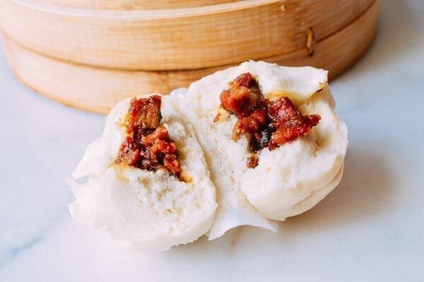 two pieces of food sitting on top of a white counter next to a wooden container