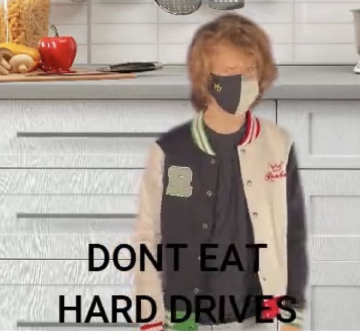 a woman wearing a face mask in the kitchen