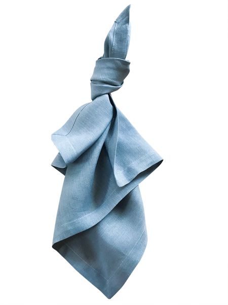 a blue tie is hanging on a white wall and it looks like something out of the wind