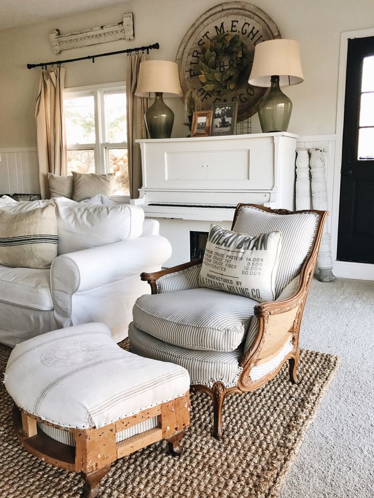 a living room filled with furniture and a white piano in the middle of the room