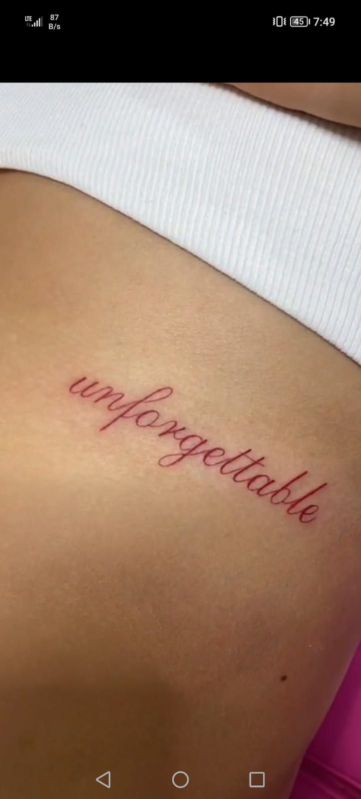 a woman's stomach with the word imppoetable written on her lower back