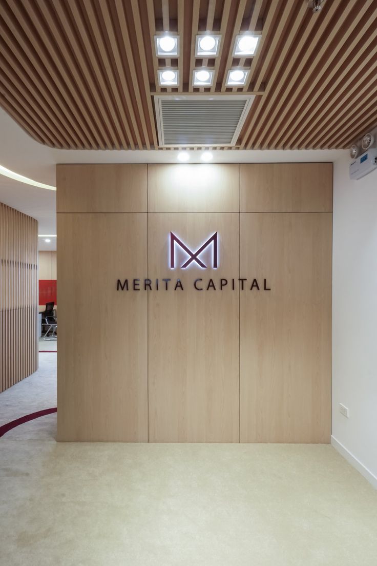 the interior of a modern office building with wood paneling and logo on the wall