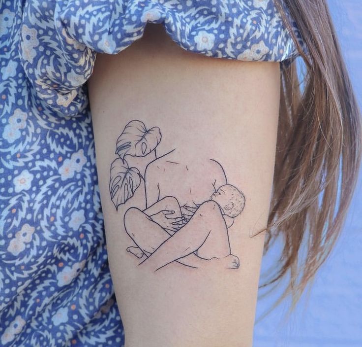 a woman's arm with a small tattoo on it that has a drawing of a girl hugging a boy