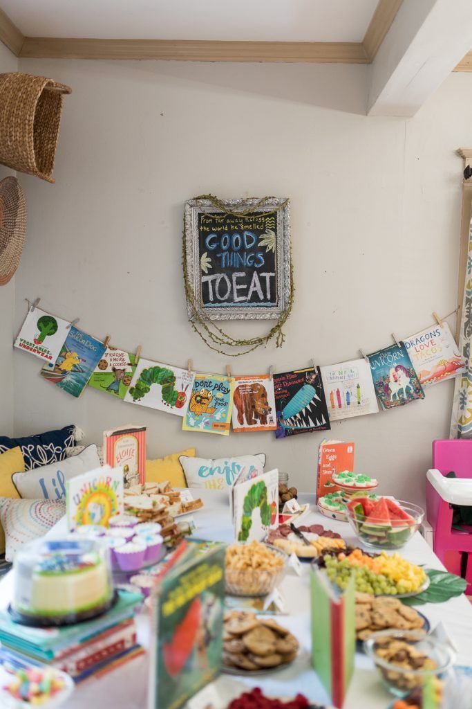 a table filled with lots of food on top of a white tablecloth covered table