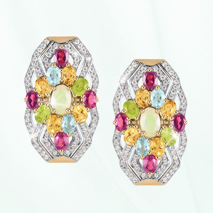 A celebration of artistry and color. Finely crafted from sterling silver, finished in 18k yellow gold, this ornate ensemble is a testament to your timeless style. An intricate arrangement of colorful gemstones, each chosen for its unique charm creates a charming focal point. An opulent Opal sits at the heart, surrounded by radiant Rhodolites, warm Citrines, refreshing Peridots and serene Blue Topaz. The dynamic interplay of hues creates a mesmerizing kaleidoscope that captures attention and sparks conversation. Embrace the enchantment of this collection and let your style speak volumes with every step. Luxury Multicolor Gemstones With Accents, Yellow Gemstones With Accents Fine Jewelry, Heirloom Multicolor Oval Jewelry, Fine Jewelry Multicolor Oval Gemstones, Luxury Multicolor Multi-stone Gemstones, Dazzling Multicolor Multi-stone Jewelry, Exquisite Multicolor Multi-stone Jewelry, Exquisite Multicolor Oval Jewelry, Luxury Yellow Multi-stone Jewelry