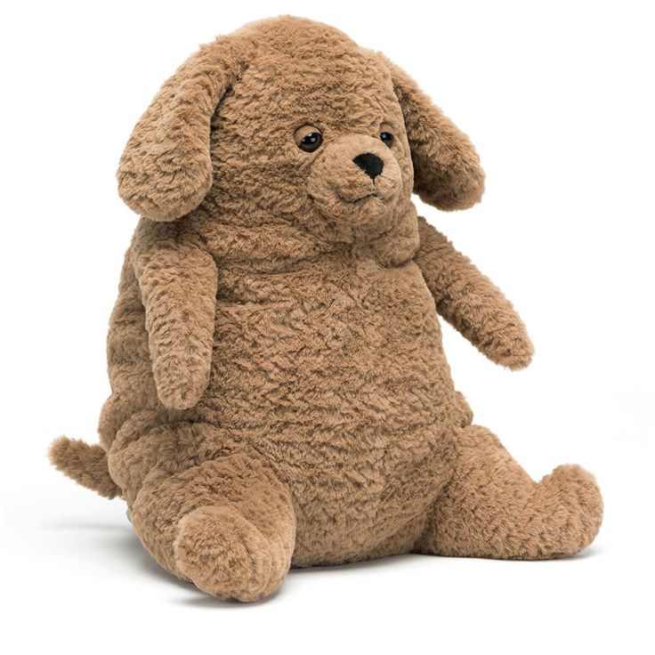 a brown stuffed dog sitting on the ground