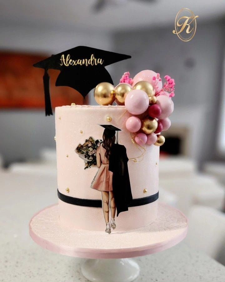 a cake decorated with balloons and a graduation cap