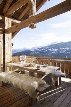 a table and benches on a wooden deck