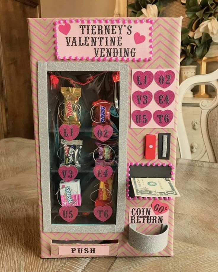 a valentine's vending machine is decorated with pink and silver trimmings