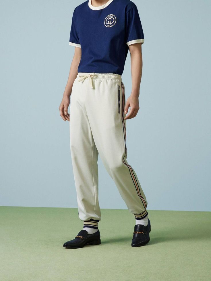 logo-patch striped-detailing track pants from Gucci featuring cotton, jersey knit, signature Interlocking G logo, logo patch to the rear, side stripe detailing, elasticated drawstring waistband, front zip fastening pockets, rear patch pocket, elasticated ankles and white. This item is in size L and the color is Gucci Casual Loungewear Bottoms, Casual Gucci Cotton Bottoms, Casual Gucci Bottoms, Gucci Pants, G Logo, Side Stripe, Drawstring Waistband, Track Pants, Patch Logo