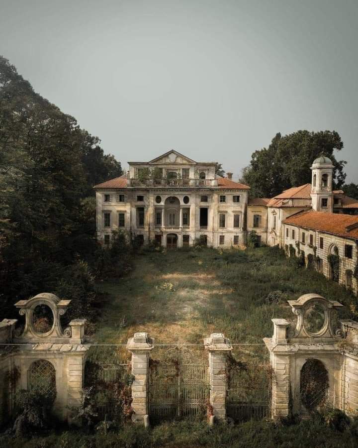 an old mansion on top of a hill