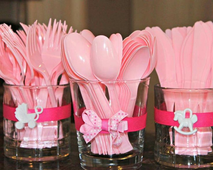 pink plastic utensils in glass cups with bows