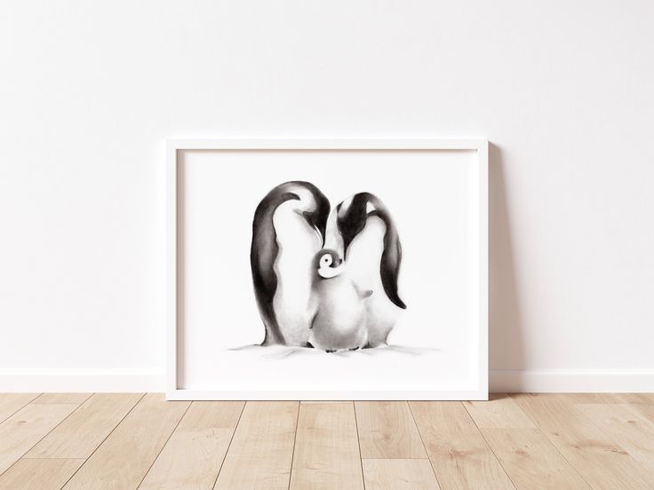 a black and white photo of two penguins