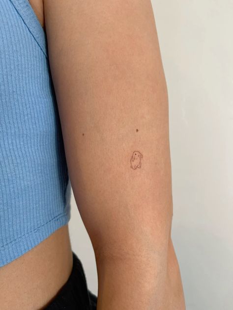 a woman's arm with a small tattoo on the left side of her arm