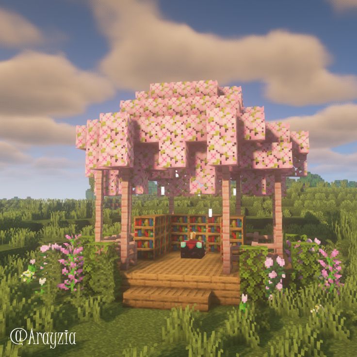 a small house made out of blocks in the middle of a field with flowers and trees