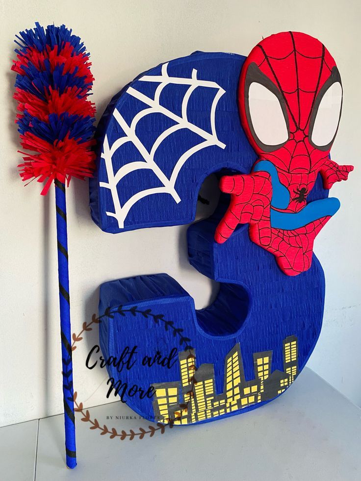 a wooden sign with a spiderman on it next to a toothbrush and broom