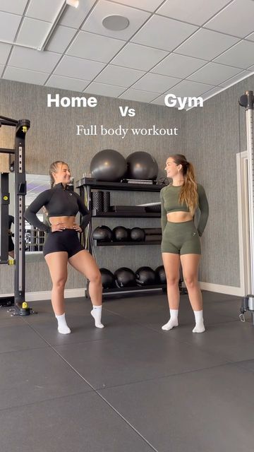 two women standing in front of a gym equipment