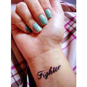 a woman's wrist tattoo with the word fighter on it