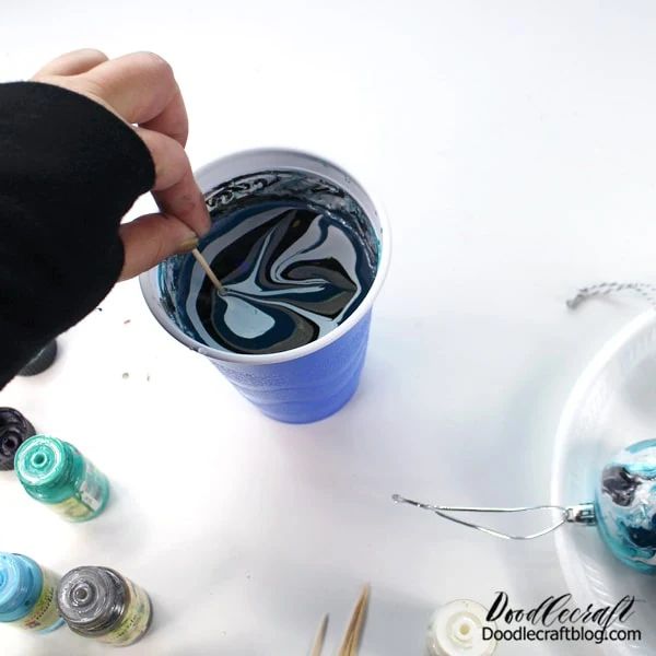 someone is painting the inside of a cup