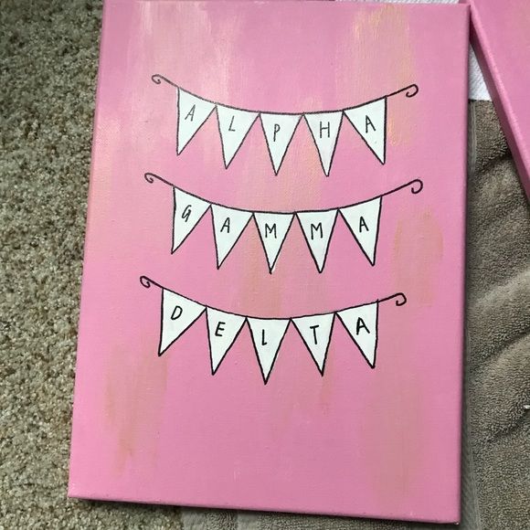 a pink canvas with white pennants on it