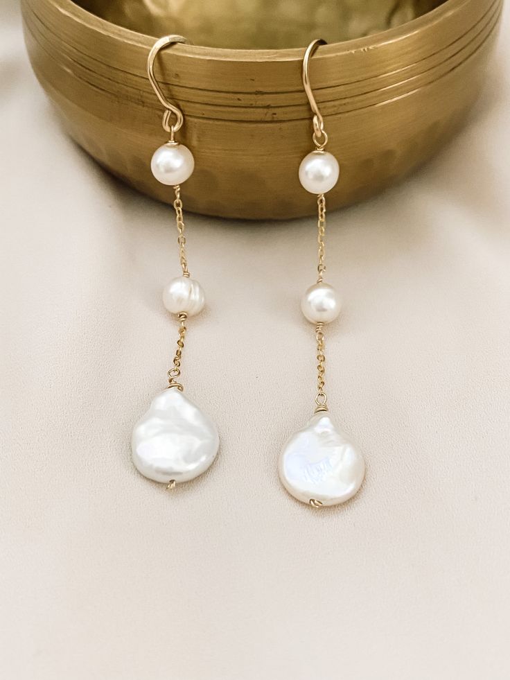 These are perfect for wear every day, with our 3 Pearl dangle earrings you are elegant with them. Is fashionable at any time. If you like simple, classy, and Unique jewelry, these earrings are perfect for you. They make elegant, versatile earrings. Details: - material: 14k gold-filled 14k rose gold-filled sterling silver - measure: 3 inches - Gems: freshwater round pearl and coin pearl (free-form) ADDITIONAL INFORMATION These earrings have been created by hand so no two pieces are identical. Eac Elegant Silver Pearl Earrings With 14k Gold Filled, Chic 14k Gold-filled Drop Earrings, Minimalist Gold Sterling Silver Bridal Earrings, Minimalist Gold Bridal Earrings In Sterling Silver, Elegant White 14k Gold Filled Bridal Earrings, Elegant 14k Gold-filled Hoop Earrings For Pierced Ears, 14k Rose Gold Pearl Earrings For Pierced Ears, Chic 14k Gold Filled Drop Earrings, Elegant 14k Gold Filled Hoop Earrings As Gift