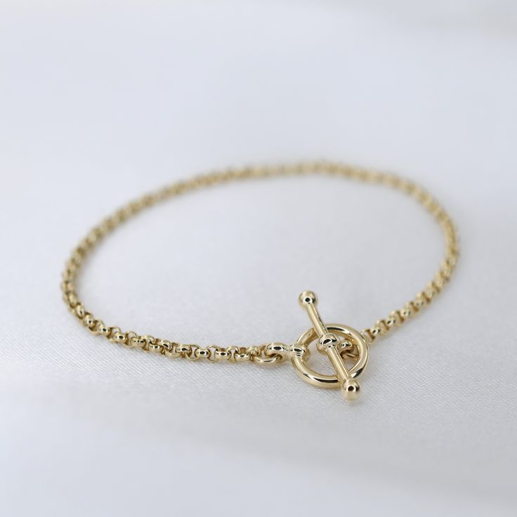 "14K GoldToggle Rolo Chain Bracelet - 14K Gold 2mm Rolo Chain Bracelet ★ 14K gold 2mm rolo chain ★ 14K gold toggle clasp ★ All components are 14K solid yellow gold The length includes the chain and the closure. Please measure your wrist before you place your order. ** How to choose a correct size of bracelet. 1. Measure your wrist below the wrist bone using a flexible tape measures, a string or a strip of paper. 2. If using a string or a strip of paper, mark length. Then, measure it with a ruler Everyday Yellow Gold Chain Bracelet With Toggle Clasp, Yellow Gold Plated Bracelet With Toggle Clasp, Yellow Gold-plated Bracelet With Toggle Clasp, Classic Yellow Gold Bracelet With Toggle Clasp, Classic Gold Bracelet With Toggle Clasp, Everyday Yellow Gold Bracelets With Toggle Clasp, Elegant Yellow Gold Bracelet With Toggle Clasp, Everyday Chain Bracelet With Toggle Clasp, Classic Yellow Gold Chain Bracelet With Toggle Clasp