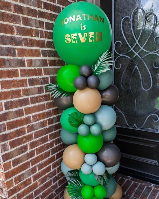 balloons are stacked on top of each other in front of a door