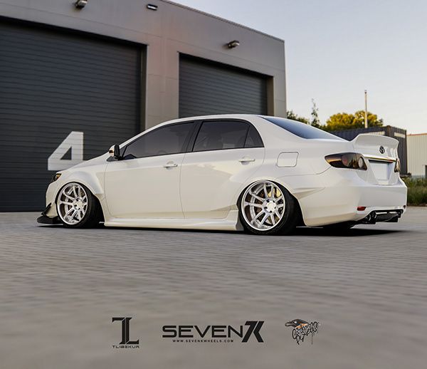 a white car parked in front of a garage