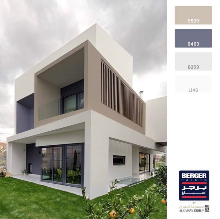 the exterior of a modern house with white and gray paint scheme on it's walls