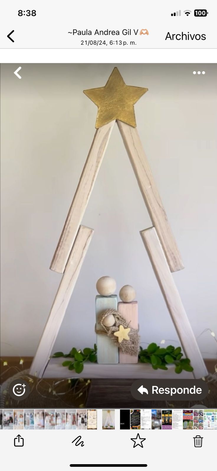 an image of a christmas tree made out of wood and decorated with gold star on top