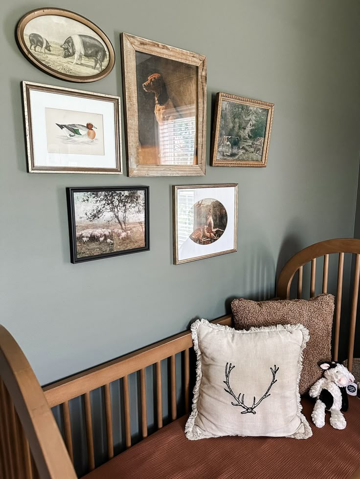 a baby's crib with pictures on the wall