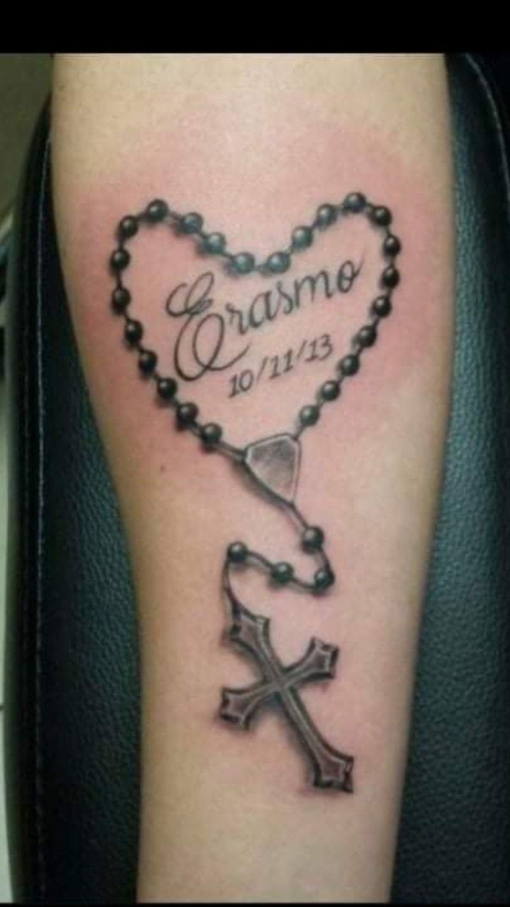 a cross and rosary tattoo on the arm