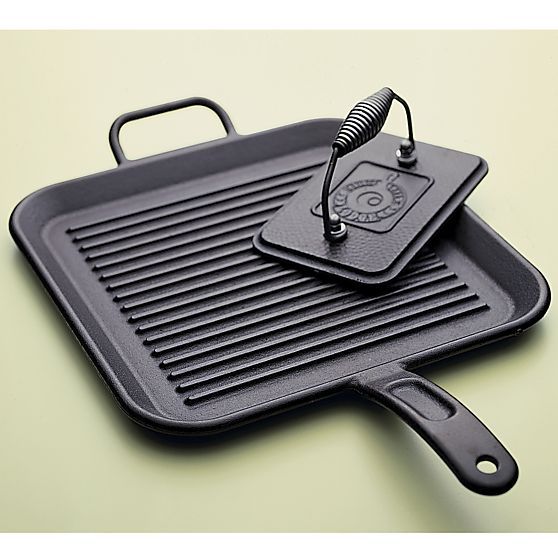 a cast iron skillet with a spatula attached to the griddle on top