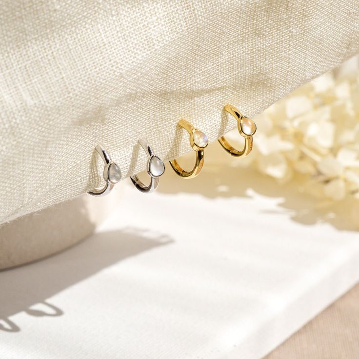 A pair of delicate Moonstone mini huggie hoop earrings in 14k yellow gold or white gold plated 925 sterling silver. These minimalist dainty earrings feature a small natural moonstone hoop.  Stack these gold moonstone earrings with -  Starburst opal hoop earrings: https://www.etsy.com/uk/listing/1341094262/genuine-opal-star-hoop-earrings-in-14k Moonstone gold necklace: https://www.etsy.com/uk/listing/1181311651/natural-moonstone-star-necklace-in-14k Moonstone gold ring: https://www.etsy.com/uk/li Dainty White Gold Tarnish-resistant Huggie Earrings, Dainty White Sterling Silver Huggie Earrings, Minimalist White Huggie Earrings For Anniversary, Dainty White Round Huggie Earrings, Minimalist White Hoop Earrings For Anniversary, Dainty White Gold Small Hoop Cartilage Earrings, Delicate White Gold Huggie Earrings For Anniversary, Dainty White Gold Tarnish Resistant Cartilage Earrings, Dainty White Gold Hoop Earrings